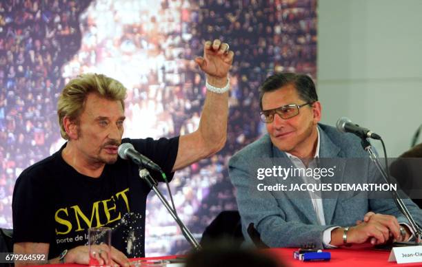 French singer Johnny Hallyday gives a press conference to announce his european tour "Flashback-Tour" flanked by his productor Jean-Claude Camus , 31...