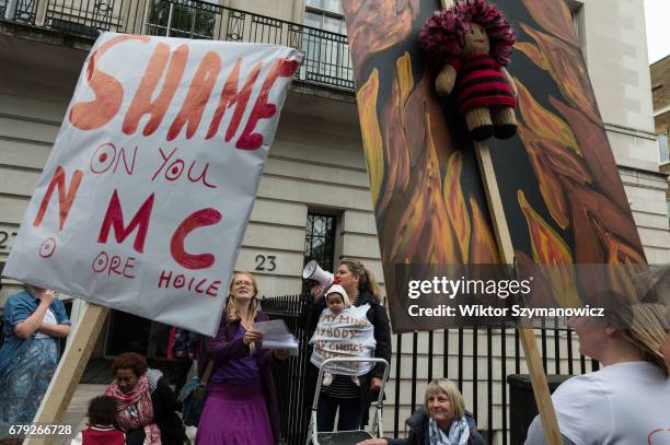 Midwives, nurses and parents gather outside the Nursing and Midwifery Council in London to protest against council's lack of protection and incorrect...