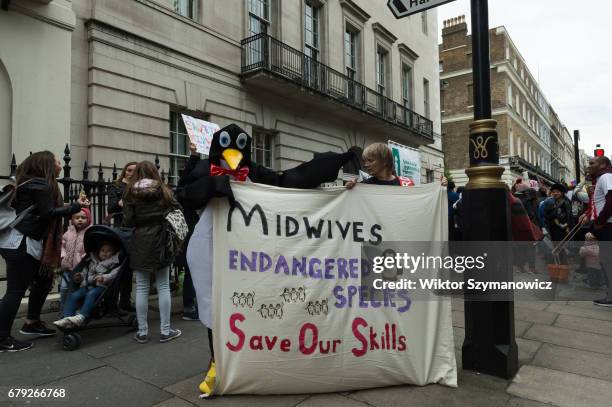 Midwives, nurses and parents gather outside the Nursing and Midwifery Council in London to protest against council's lack of protection and incorrect...