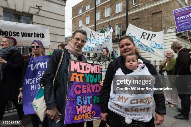 Midwives, nurses and parents gather outside the Nursing and Midwifery Council in London to protest against council's lack of protection and incorrect...