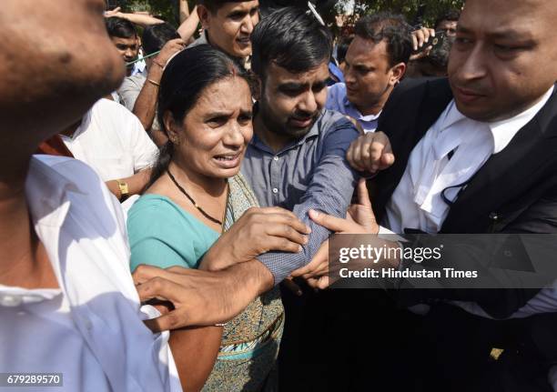 Mother of the victim coming out of the Supreme Court, after the court pronounced verdict on the appeals filed by four death row convicts against...