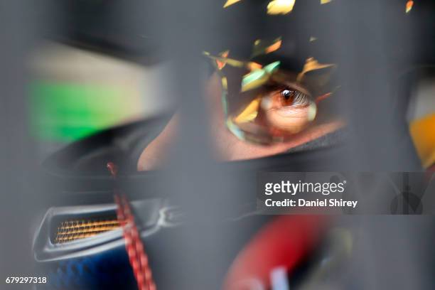 Brennan Poole, driver of the DC Solar Chevrolet, sits in his car during practice for the NASCAR XFINITY Series Sparks Energy 300 at Talladega...