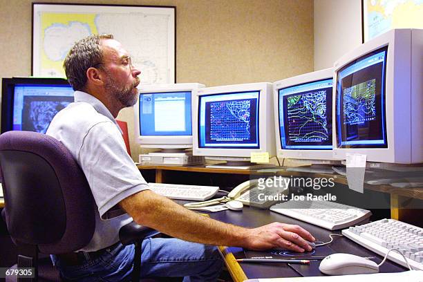Meteorologist Larry Lahiff tracks the path of Hurricane Michelle at the United States National Hurricane Center November 3, 2001 in Miami, FL. The...
