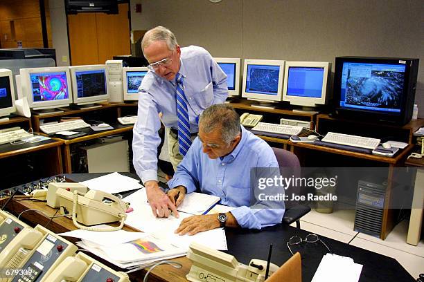 National Hurricane Center Director Max Mayfield and meteorologist Miles Lawrence study and track the path of Hurricane Michelle at the United States...