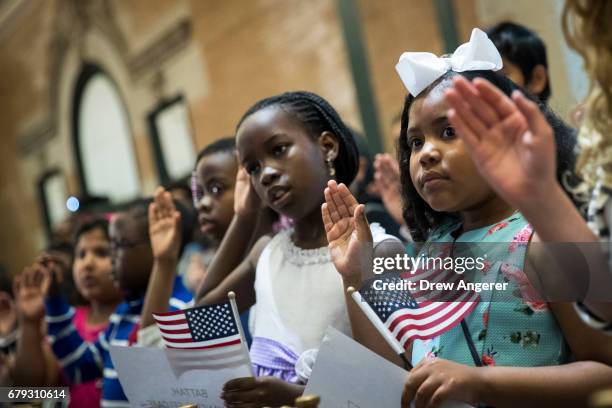 Children take the Oath of Allegiance as they become U.S. Citizens during a citizenship ceremony at The Bronx Zoo, May 5, 2017 in The Bronx borough of...