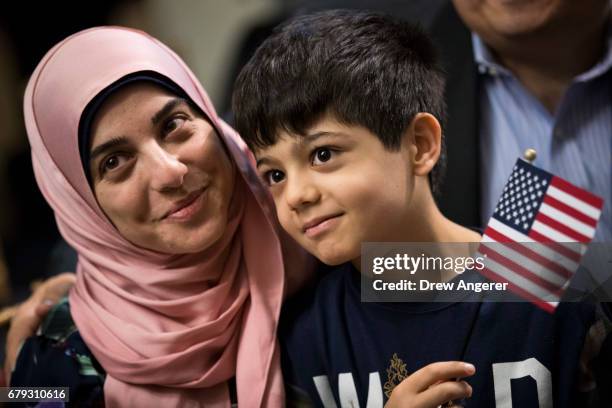 Ali Younes, an 8 year-old from Lebanon, sits with his mother after becoming a U.S. Citizen during a citizenship ceremony at The Bronx Zoo, May 5,...