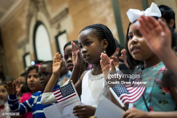 Children take the Oath of Allegiance as they become U.S. Citizens during a citizenship ceremony at The Bronx Zoo, May 5, 2017 in The Bronx borough of...