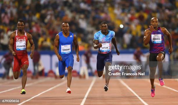 Femi Ogunode of Qatar, Akani Simbine of South Africa, Justin Gatlin of the United States and Asafa Powell of Jamaica compete in the Men's 100 metres...