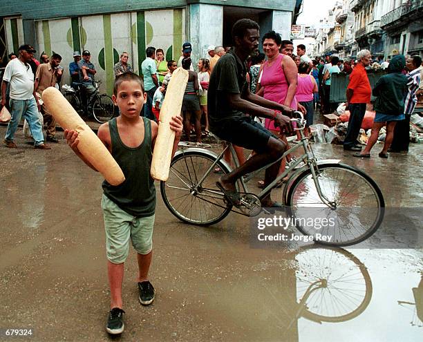 Young Cuban walks home after purchasing bread November 3, 2001 in Havana, Cuba. Cubans are preparing for Hurricane Michelle, which is considered to...