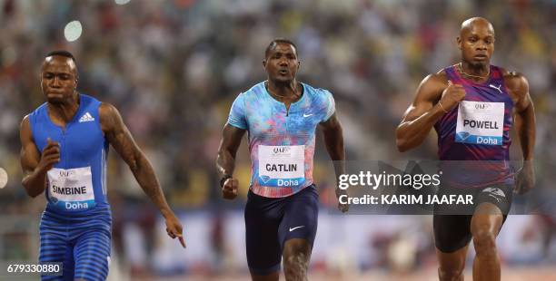 South Africa's Akani Simbine, US' Justin Gatlin and Jamaica's Asafa Powell compete in the men's 100 metres during the Diamond League athletics...