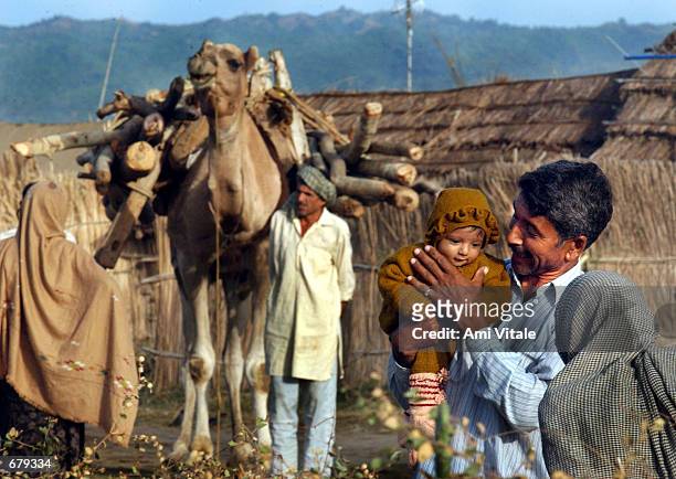 Displaced Indians who fled their villages near the border region of Pallanwala in June of 1999 gather November 4, 2001 in a camp near Akhnur, India.