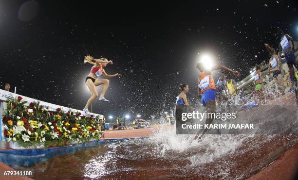 Athletes compete in the women's 3000 metres steeplechase during the Diamond League athletics competition at the Suhaim bin Hamad Stadium in Doha, on...