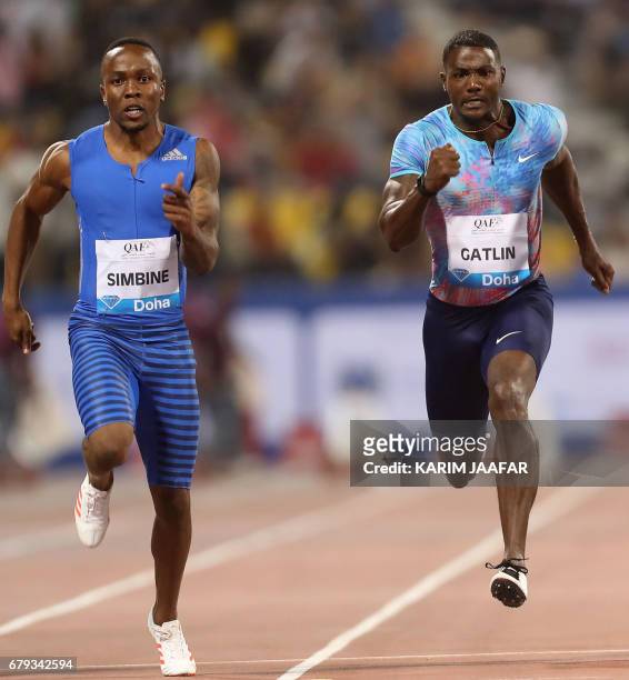 South Africa's Akani Simbine and US' Justin Gatlin compete in the men's 100 metres during the Diamond League athletics competition at the Suhaim bin...