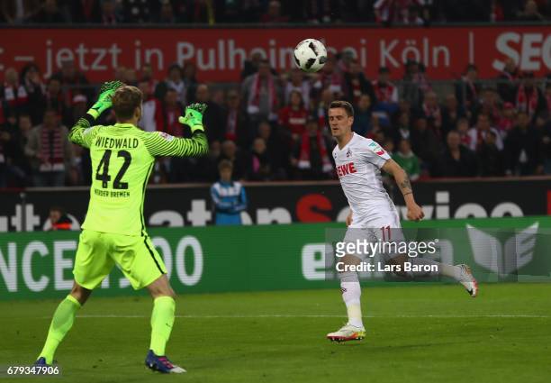 Simon Zoller of Koeln chips the ball over Felix Wiedwald of Bremen to score the third goal during the Bundesliga match between 1. FC Koeln and Werder...
