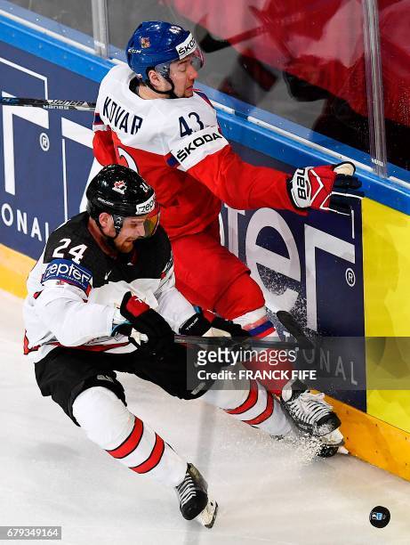 Canada's defender Calvin de Haan fights for the puck with Czech Republic's forward Jan Kovar during the IIHF Men's World Championship group B ice...