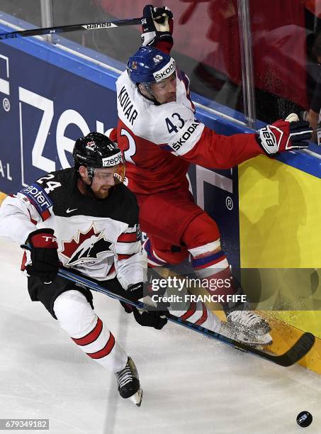 Canada's defender Calvin de Haan fights for the puck with Czech Republic's forward Jan Kovar during the IIHF Men's World Championship group B ice...