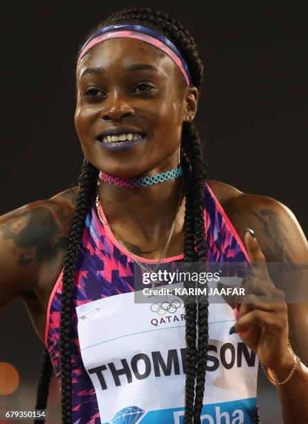 Jamaica's Elaine Thompson celebrates after winning the women's 200 metres during the Diamond League athletics competition at the Suhaim bin Hamad...