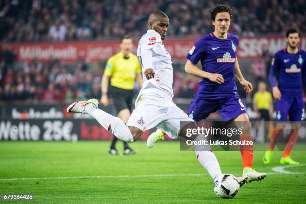 Anthony Modeste of Koeln is challenged by Thomas Delaney of Bremen and scores his teams fourth goal during the Bundesliga match between 1. FC Koeln...