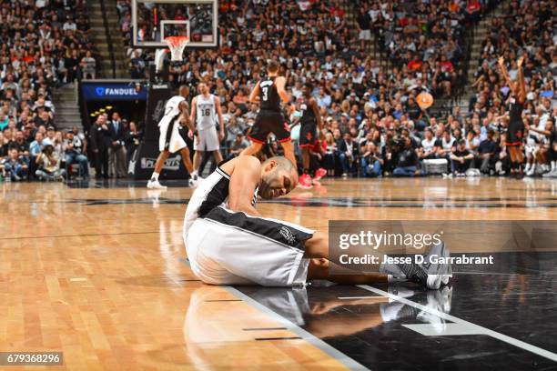 Tony Parker of the San Antonio Spurs holds his knee after sustaining an injury during Game Two of the Western Conference Semifinals against the...