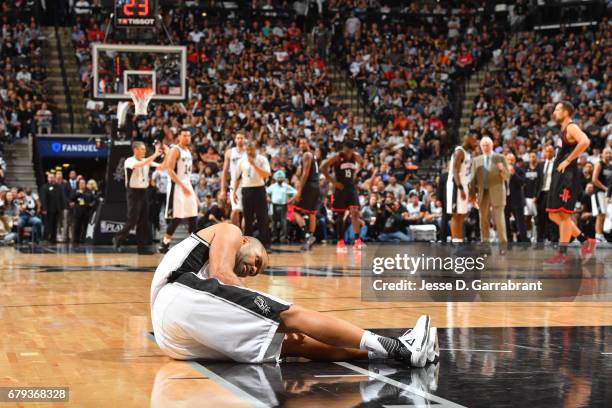 Tony Parker of the San Antonio Spurs holds his knee after sustaining an injury during Game Two of the Western Conference Semifinals against the...