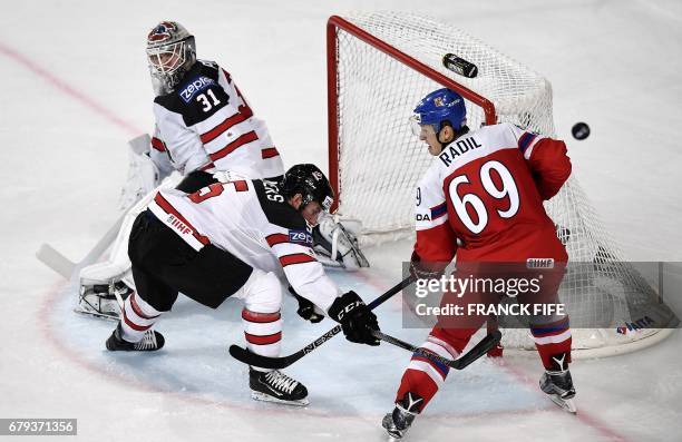 Czech Republic's forward Lukas Radil vies with Canada's defender Jason Demers during the IIHF Men's World Championship group B ice hockey match...