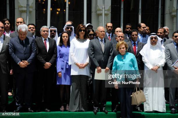 Ahmed Aboul Gheit, Arab League Secretary-General, center, and representatives of Arab league members pause in solidarity with hundreds of...