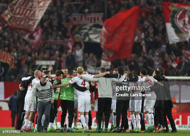 Peter Stoeger, head coach of Koeln celebrates with his players after the Bundesliga match between 1. FC Koeln and Werder Bremen at...