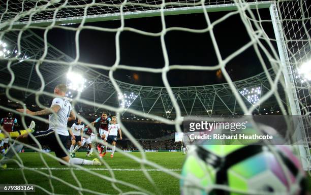 Manuel Lanzini of West Ham United scores the opening goal during the Premier League match between West Ham United and Tottenham Hotspur at the London...
