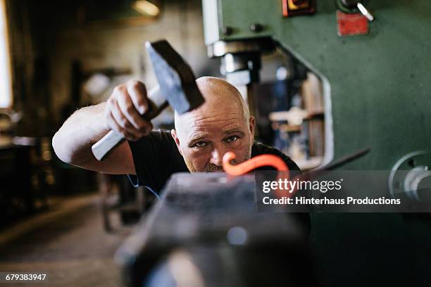 close-up of blacksmith shaping  iron - martillo herramienta de mano fotografías e imágenes de stock
