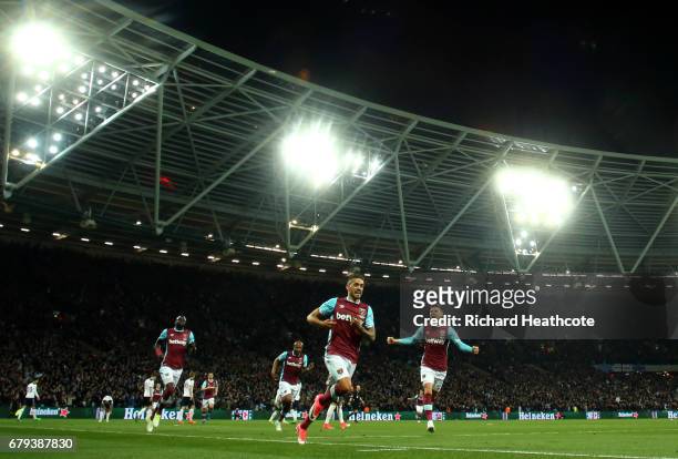 Manuel Lanzini of West Ham United celebrates scoring the opening goal during the Premier League match between West Ham United and Tottenham Hotspur...