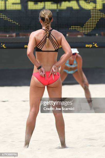 Kelley Larsen sends a signal to Betsi Flint during their match against Geena Urango and Angela Bensend at AVP Huntington Beach Open at the Huntington...