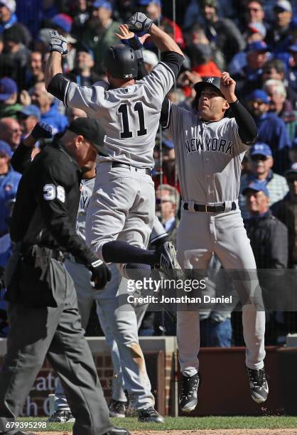 Brett Gardner of the New York Yankees celebrates with Jacoby Ellsbury after hitting a three run home ini the 9th inning against the Chicago Cubs at...