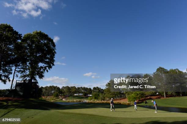 Shawn Stefani , Francesco Molinari of Italy, and Patton Kizzire walk on the 12th green during round two of the Wells Fargo Championship at Eagle...