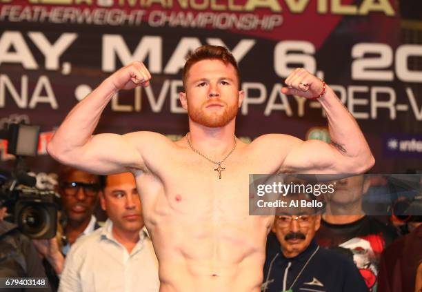 Boxer Canelo Alvarez poses on the scale during his official weigh-in at MGM Grand Garden Arena on May 5, 2017 in Las Vegas, Nevada. Alvarez will meet...