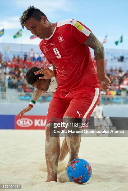 Dejan Stankovic of Switzerland is closed down by Hassan Abdollahi of Iran during the FIFA Beach Soccer World Cup Bahamas 2017 quarter final match...