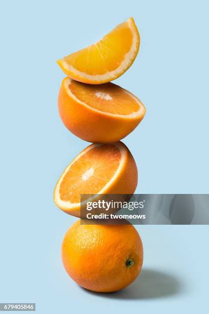 oranges stack on light blue background. - high fibre diet stock pictures, royalty-free photos & images