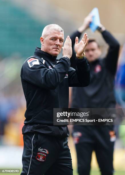 Carlisle United's manager Graham Kavanagh applauds the fans at the end of the match as they are relegated