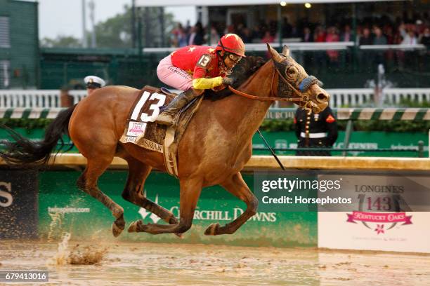 Abel Tasman, ridden by jockey Mike Smith, crosses the finish line to win the 143rd running of the Kentucky Oaks at Churchill Downs on May 5, 2017 in...