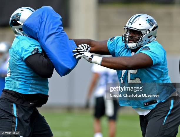 Carolina Panthers rookie tackle Taylor Moton, right, runs a drill during the second session of the team's rookie minicamp in Charlotte, N.C., on...