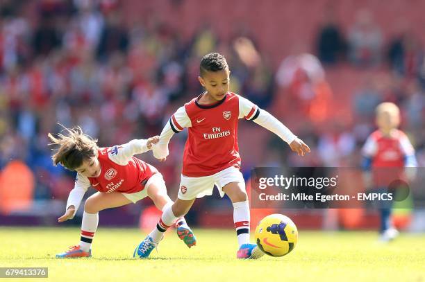 Gabriel Arteta, son of Mikel and Elias Sagna, son of Bacary play on the pitch after the game between Arsenal and West Bromwich Albion