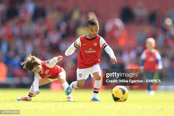 Gabriel Arteta, son of Mikel and Elias Sagna, son of Bacary (right0 play on the pitch after the game between Arsenal and West Bromwich Albion