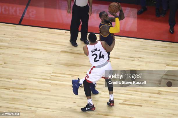 Injured, Toronto Raptors guard Norman Powell fouls LeBron James as the Toronto Raptors play the Cleveland Cavaliers in game 3 of their second round...