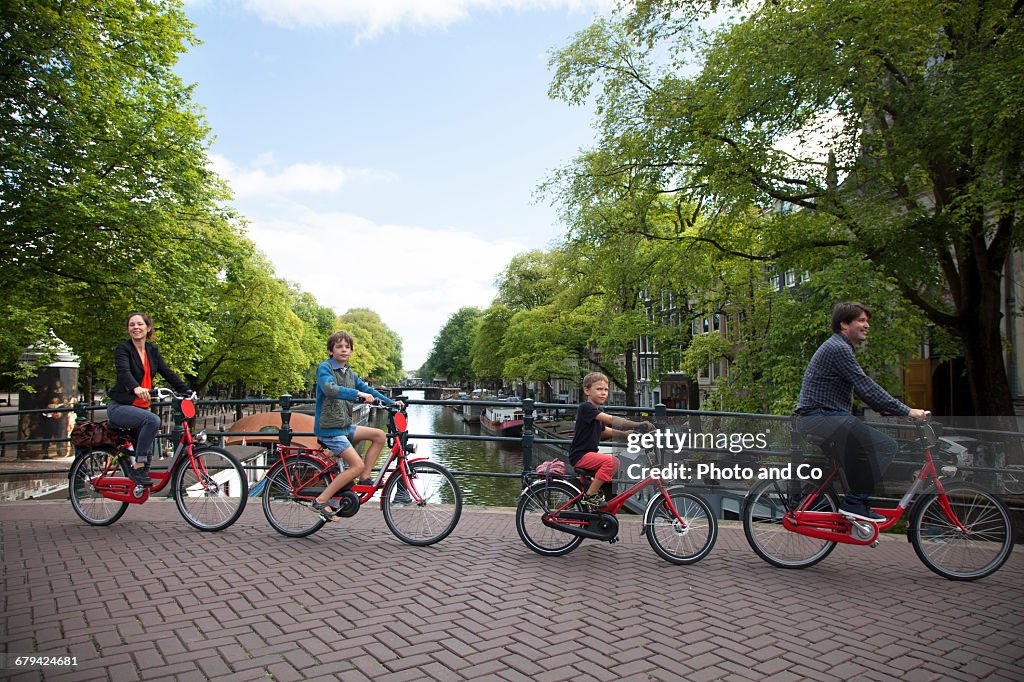 Cyclist crossing a canal bridge, Family