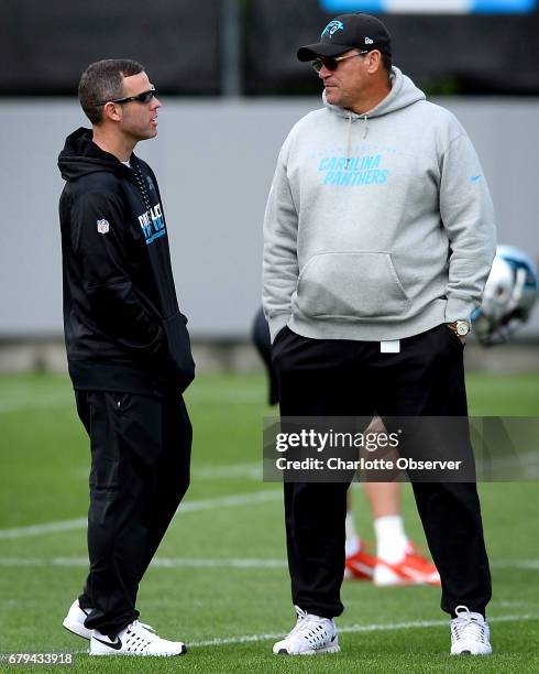 Carolina Panthers assistant general manager Brandon Beane, left, and head coach Ron Rivera talk during the second session of the team's rookie...