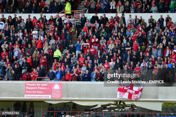 Nottingham Forest fans in the stands bearing a banner in support of club owner Fawaz Al-Hasawi