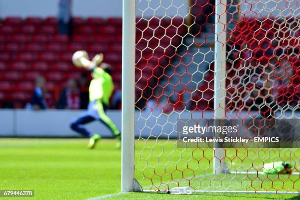 Nottingham Forest goalkeeper warms up beyond the goal mouth before the game