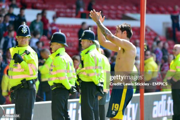 Brighton & Hove Albion's winning goalscorer Leonardo Ulloa applauds the travelling fans as he celebrates making the play-offs after victory over...