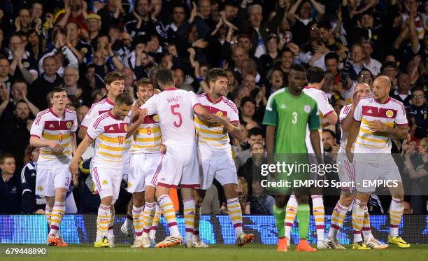 Scotland's players celebrate after Nigeria's Azubuike Egwuekwe scores an own goal