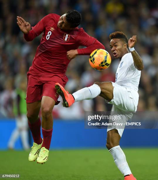 England's Raheem Sterling battles for the ball with Peru's Andre Carillo