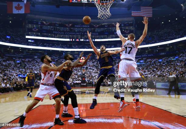 Kevin Love of the Cleveland Cavaliers shoots the ball as Jonas Valanciunas of the Toronto Raptors defends in the first half of Game Three of the...